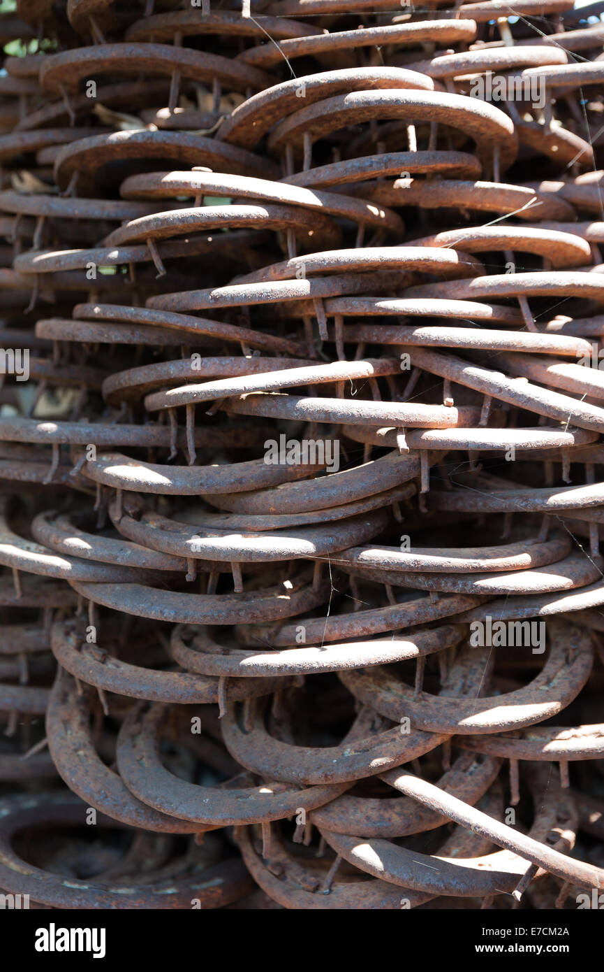 Old & used horse shoes piled up as a modern statue in an artisan shop in Los Alamos, California Stock Photo