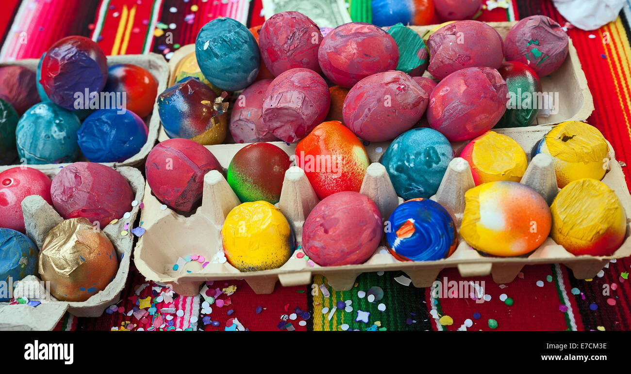 Egg shells filled with confetti & painted with different designs for