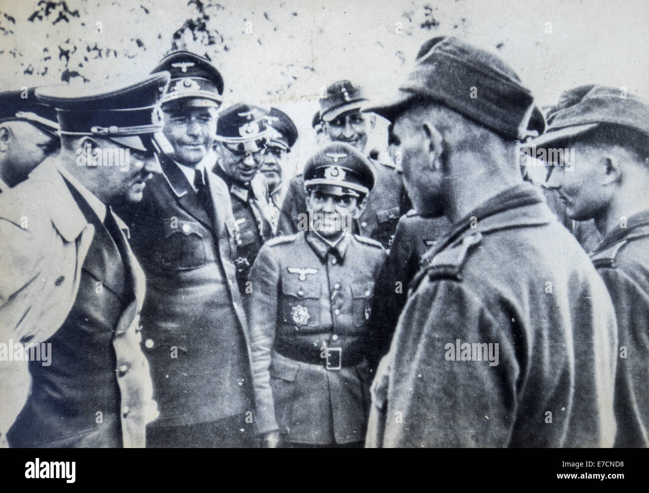 Adolf Hitler surrounded by officers talking to a soldier. Reproduction ...