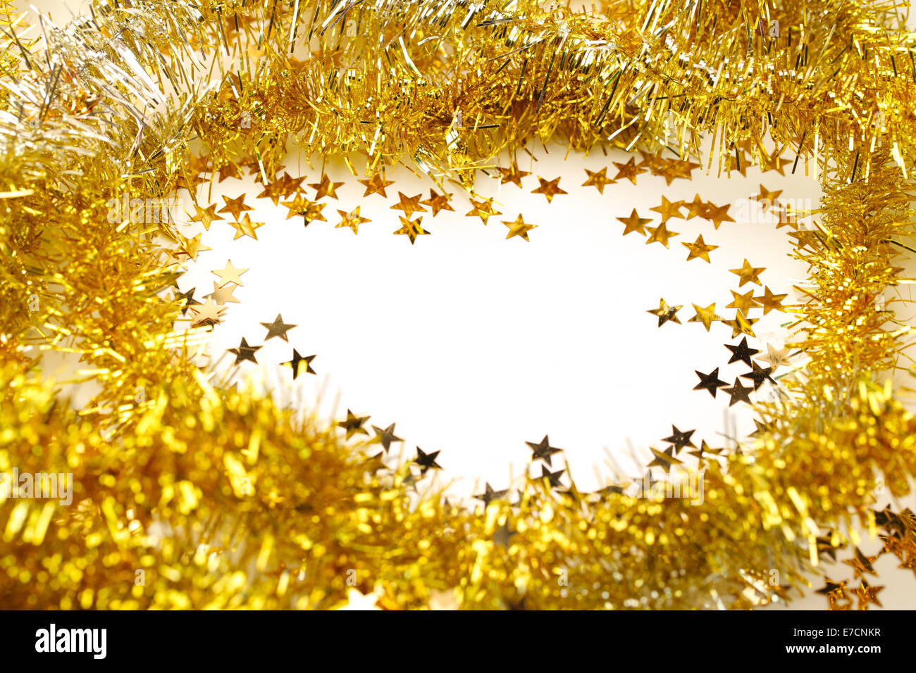 Golden tinsel garland frame and star confetti Stock Photo