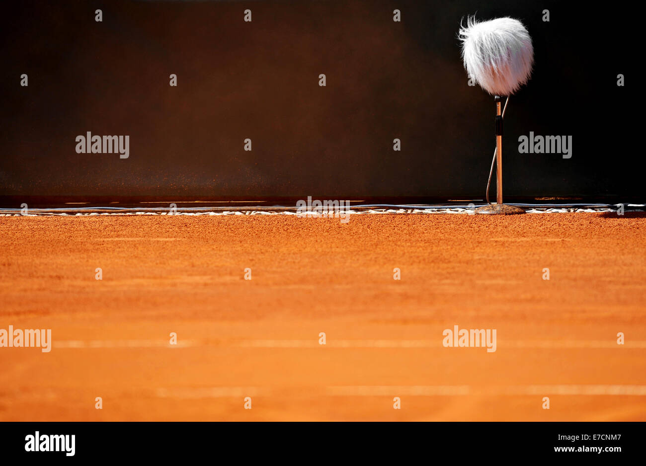 Detail with a professional sport microphone on a clay tennis court Stock Photo