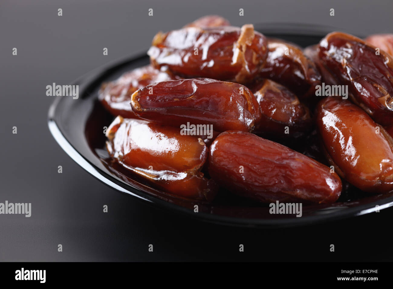 Date fruit in a black plate. Stock Photo