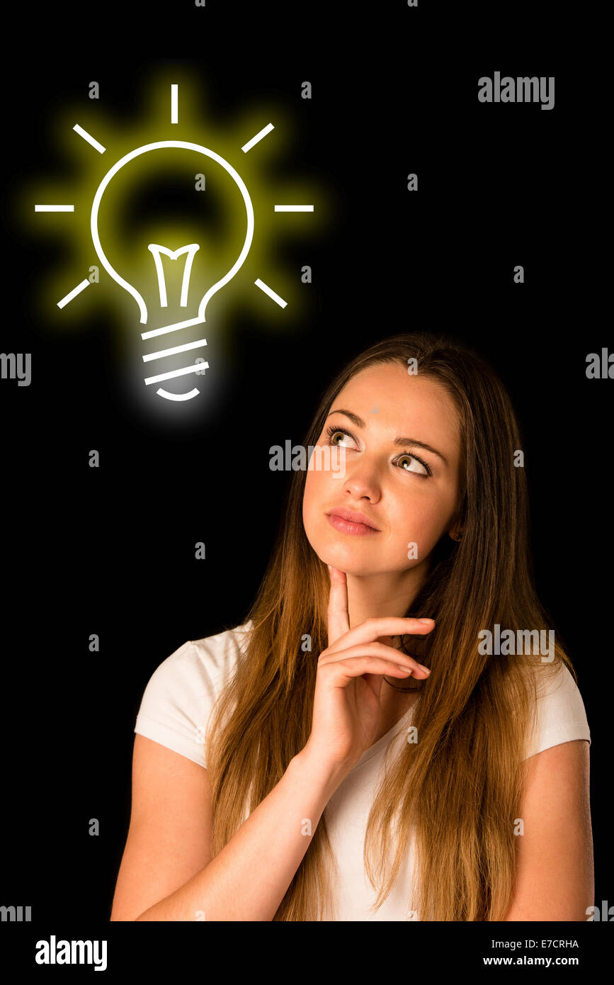 pensive asian caucasian woman looking into copyspace isolated over black Stock Photo