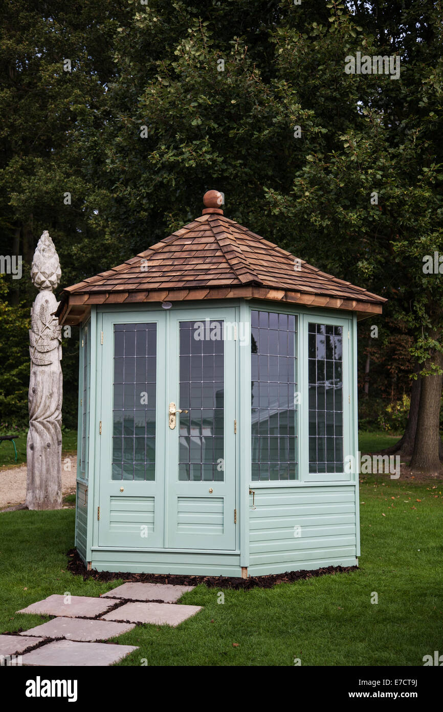 Chelsea garden shed, sheds, nature, gardening, wooden, wood, plant, spring, green, season, summer, trees and carved pole at Hatton Park Flower Show. Stock Photo