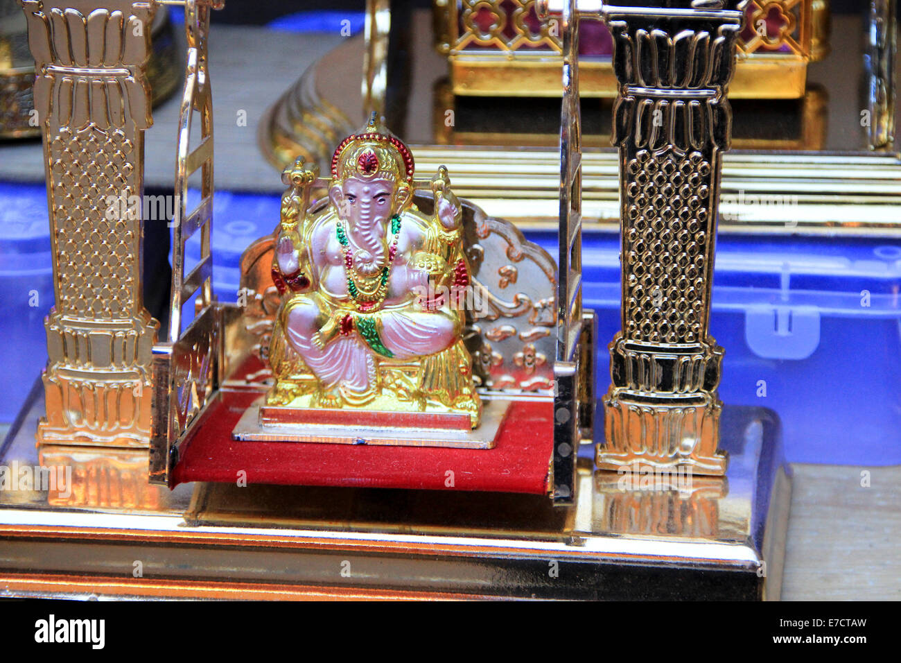 Ganesha on throne platform placed on swing with glittery frame Stock Photo