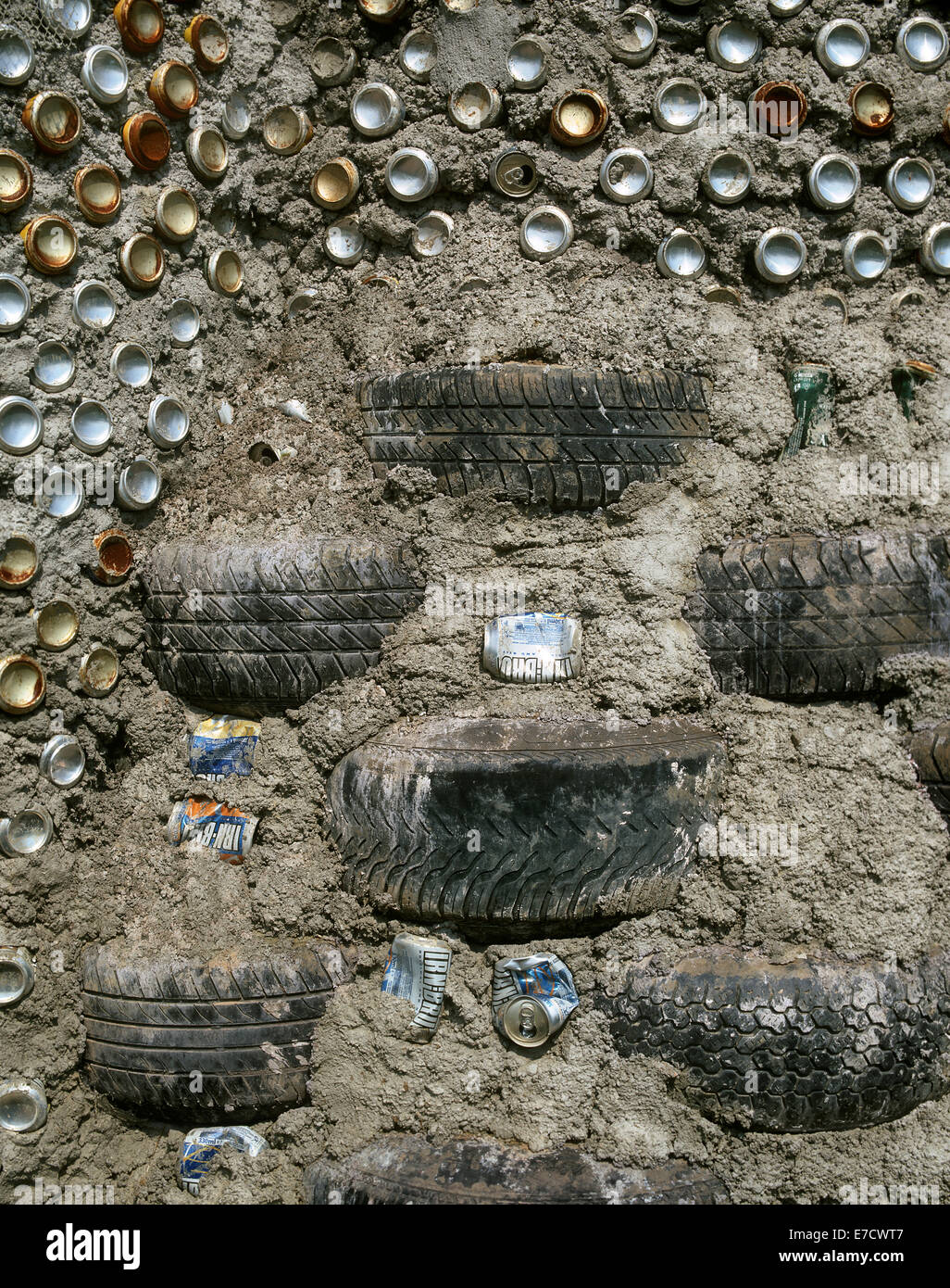 Close up of the Fife Earthship under construction showing an exposed earth wall incorporating used vehicle tyres and drinks cans. Stock Photo