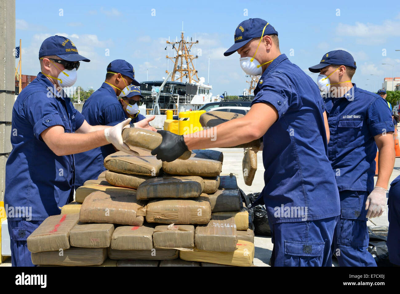The crew of the U.S. Coast Guard Cutter Paul Clark offloads an estimated 2,100 pounds of marijuana and 35 kilograms of cocaine worth a combined wholesale value of more than $3 million September 5, 2014 in Miami Beach, Florida. Stock Photo