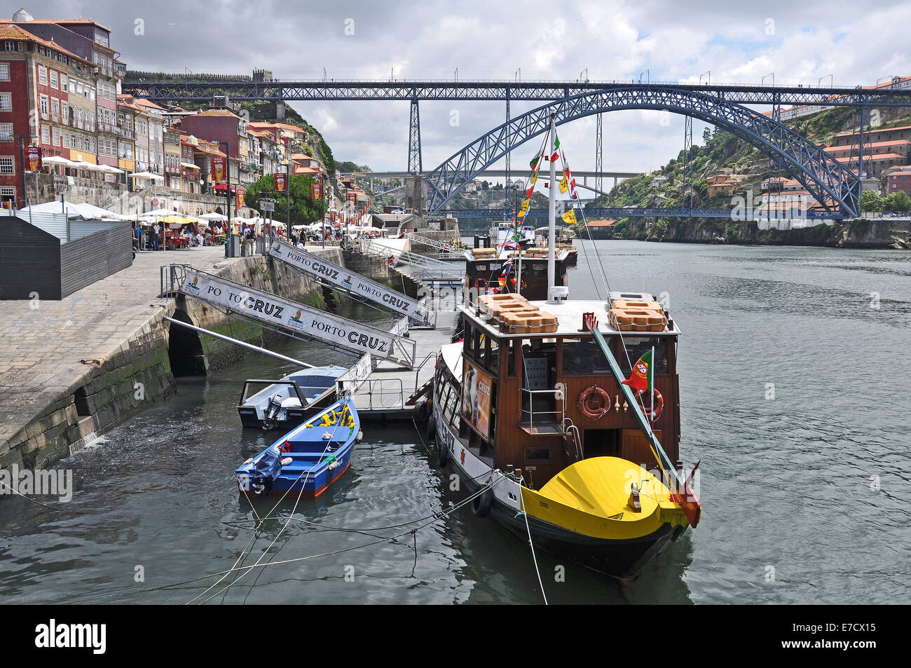 The Dom Luis Bridge and sightseeing boats on Douro River in Porto, Portugal. Stock Photo
