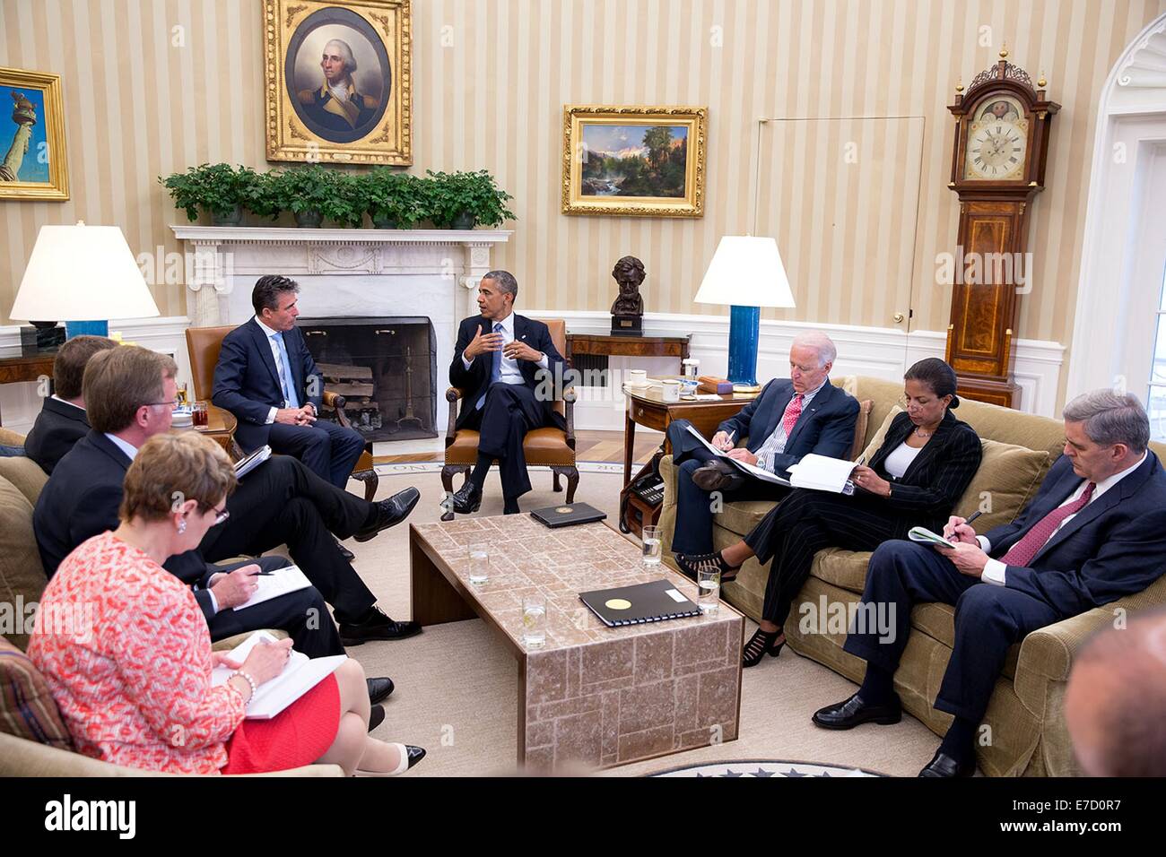 US President Barack Obama and Vice President Joe Biden meet with NATO Secretary General Anders Fogh Rasmussen to discuss the situation in Ukraine in the Oval Office of the White House July 8, 2014 in Washington, DC.  Seated at right are National Security Advisor Susan E. Rice and Doug Lute, U.S. Ambassador to NATO. Stock Photo