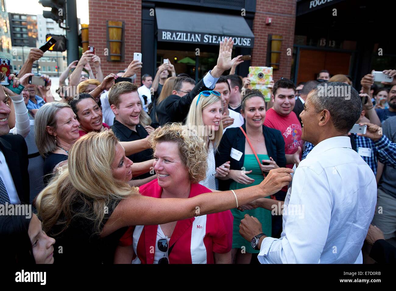 US President Barack Obama greets people gathered to meet him as he walks downtown July 8, 2014 in Denver, Colorado. Stock Photo