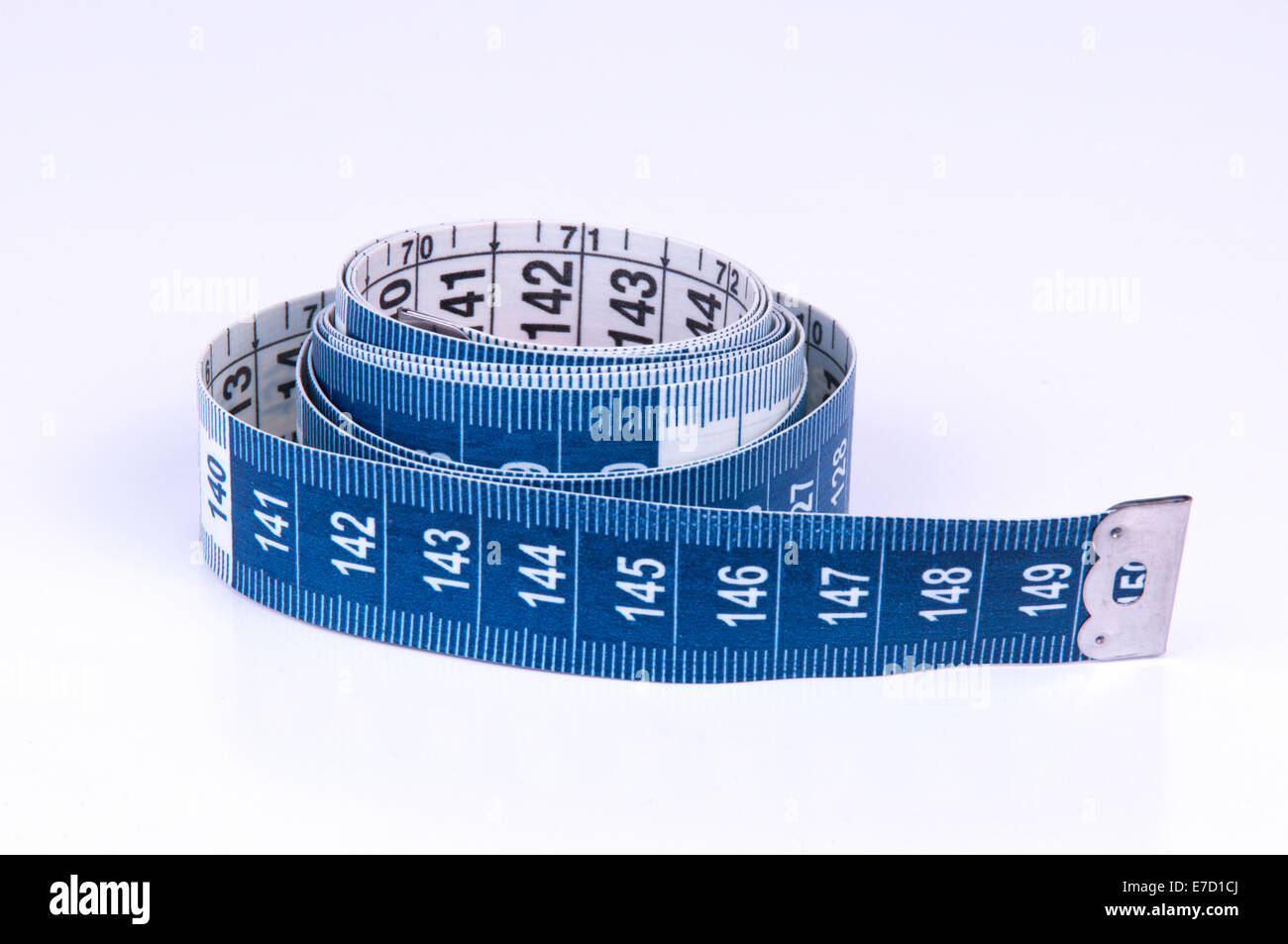A tape measure or measuring tape is a flexible ruler on white background Stock Photo