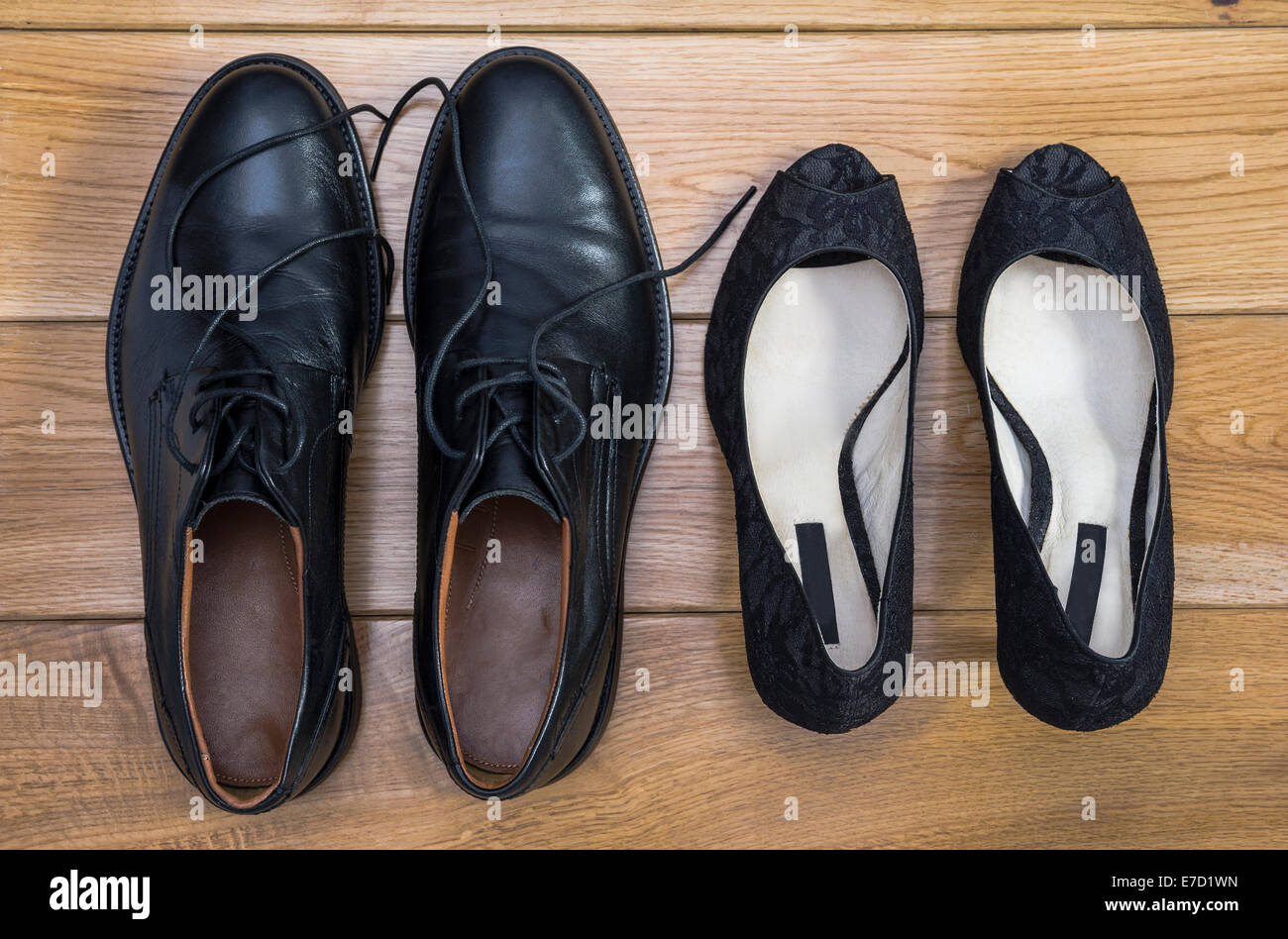 Man and womans shoes, side by side. Stock Photo