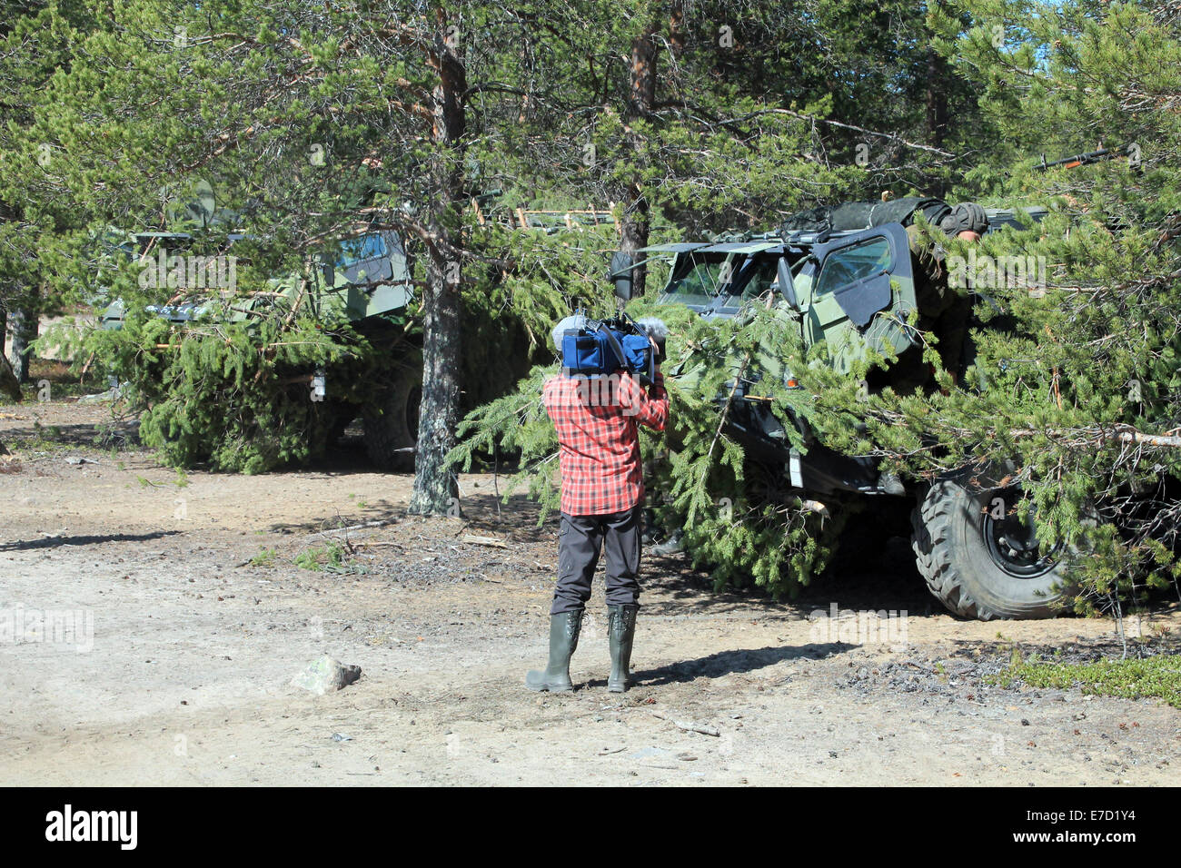 Camera man filming Finnish Defence Forces' vehicles Stock Photo