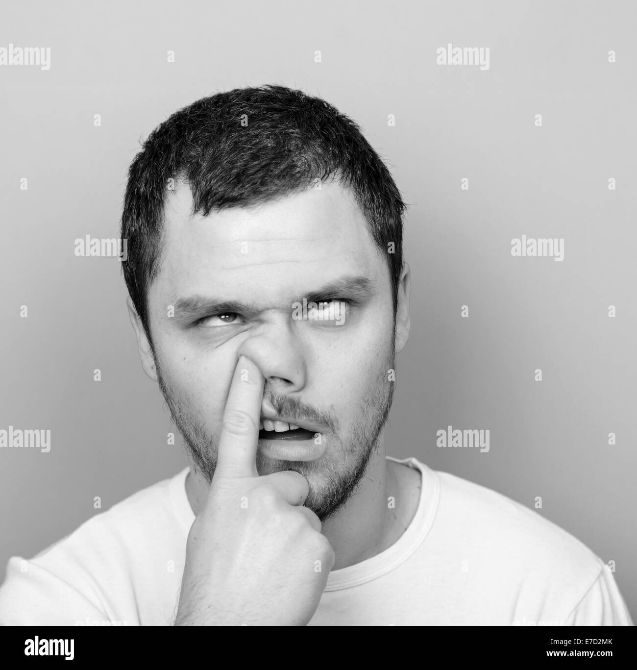 Portrait of a funny guy with finger in his nose Monocrome or black