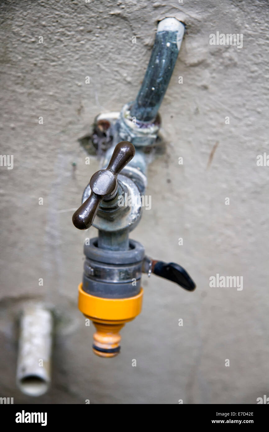 Exterior wall water tap with hose attachment Stock Photo