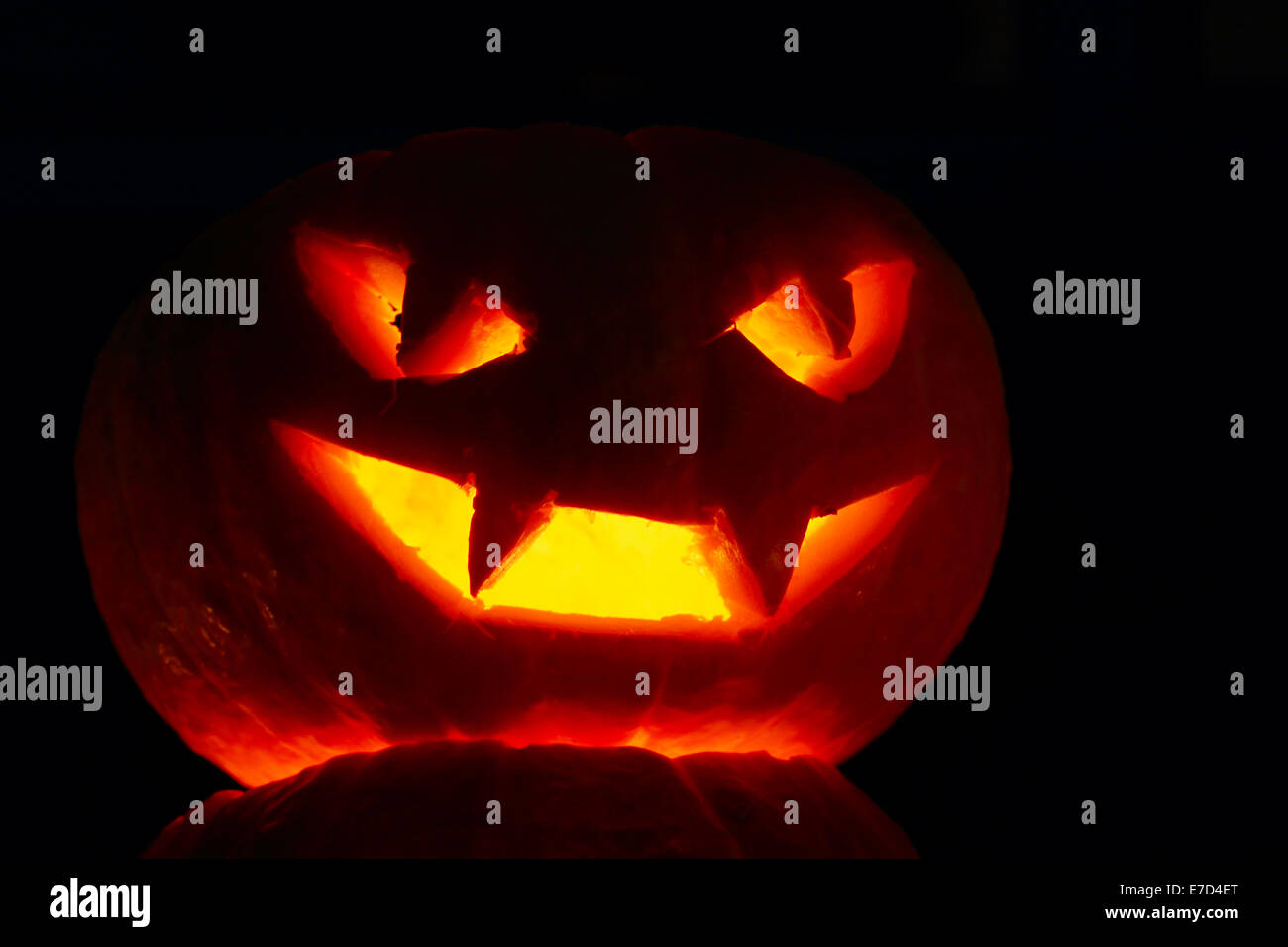 Illuminated cute halloween pumpkin isolated on black background Stock ...