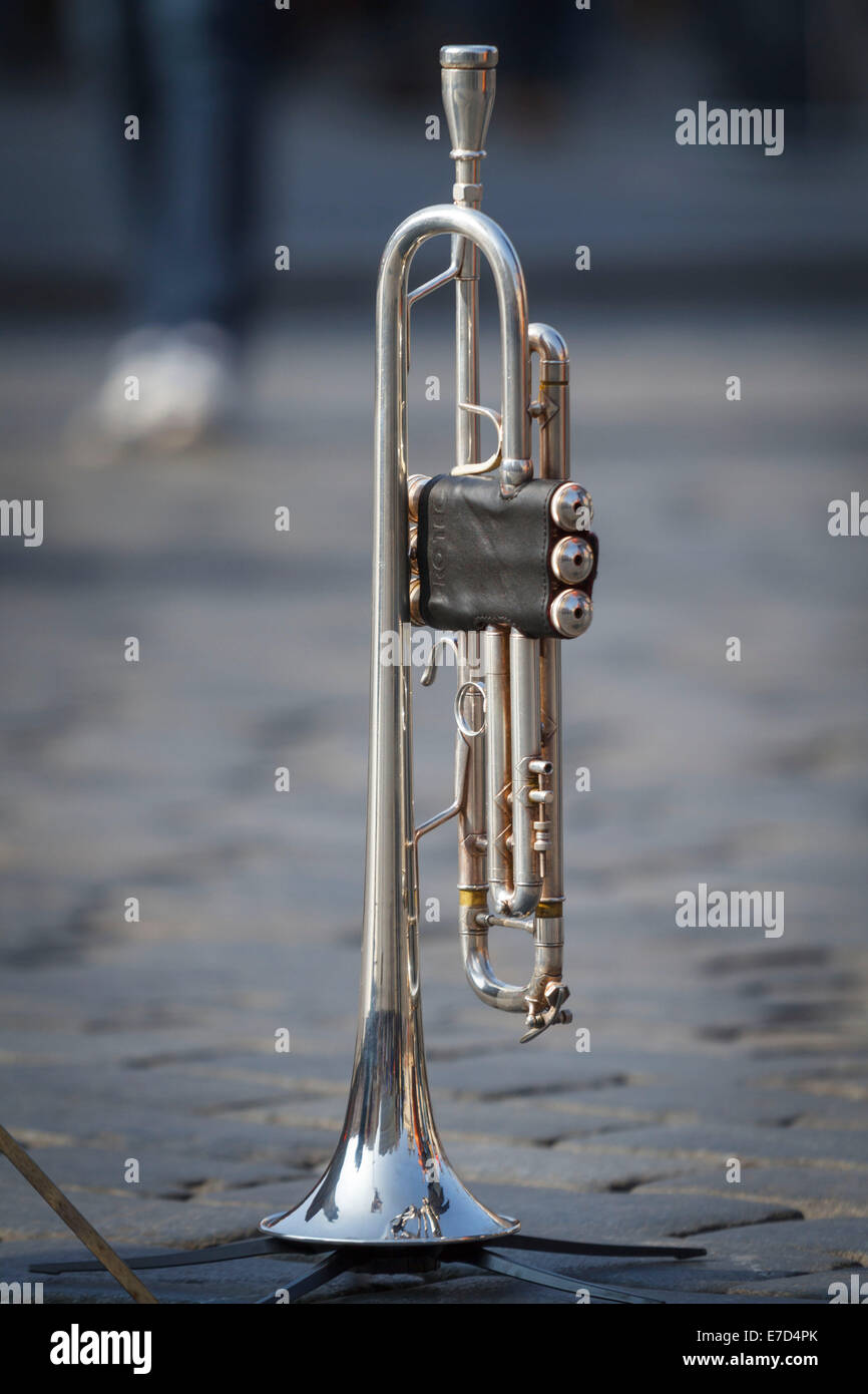 Shiny Silver Trumpet standing cobbles street performer busker reflection Stock Photo