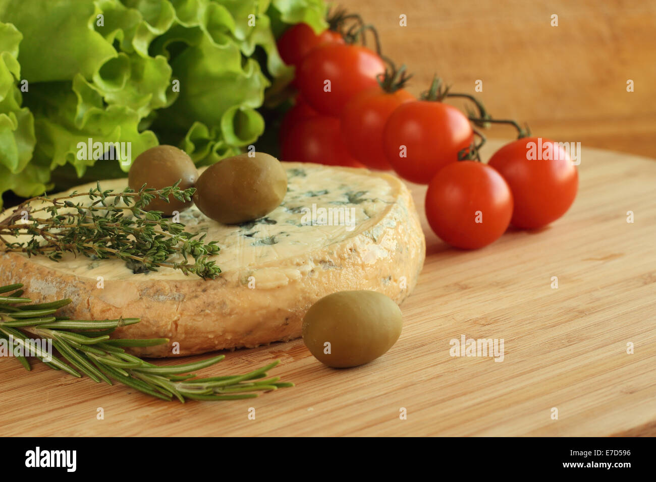 Cheese and Olives composition on wooden table Stock Photo