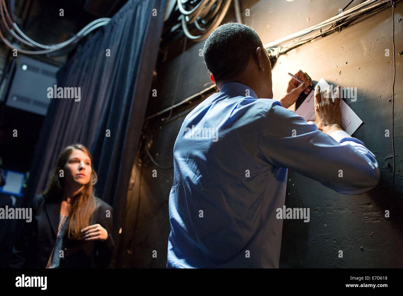 US President Barack Obama autographs a letter written by University of Texas student Kinsey Button as he waits backstage before she introduces him at the Paramount Theatre July 10, 2014 in Austin, Texas Stock Photo