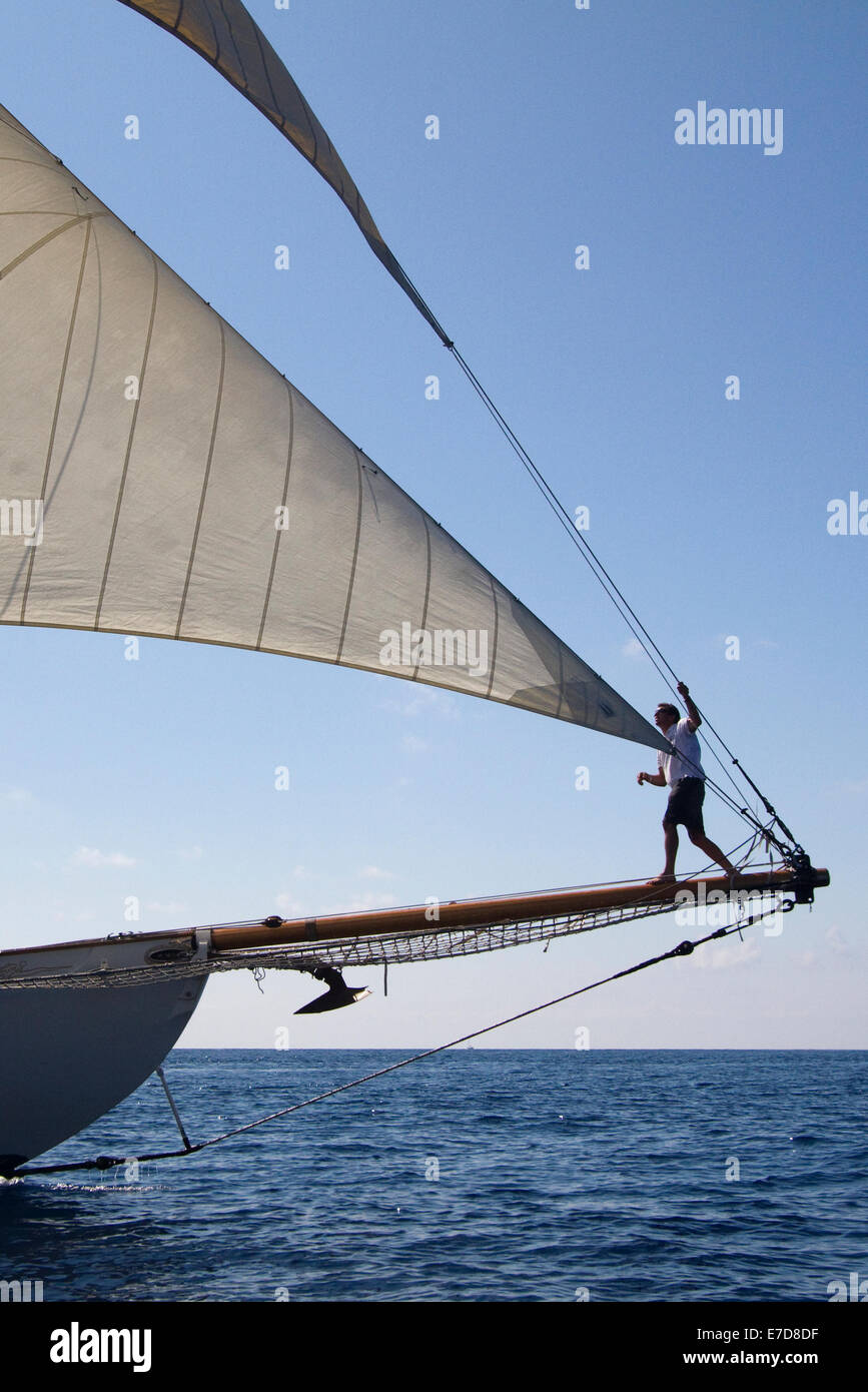 Imperia, Italy. 14th September 2014. A crew member on the bowsprit. Vele d'Epoca is a vintage yacht competition held every two years in Imperia. Stock Photo