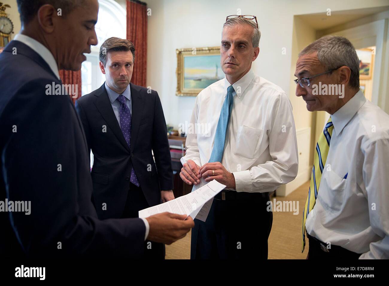 US President Barack Obama talks with advisors in the Outer Oval Office before delivering a statement on the crash of Malaysia Airlines Flight 17 and the situation in Ukraine, July 18, 2014 in Washington, DC. With the President from left are Press Secretary Josh Earnest, Chief of Staff Denis McDonough and John Podesta, Counselor to the President. Stock Photo