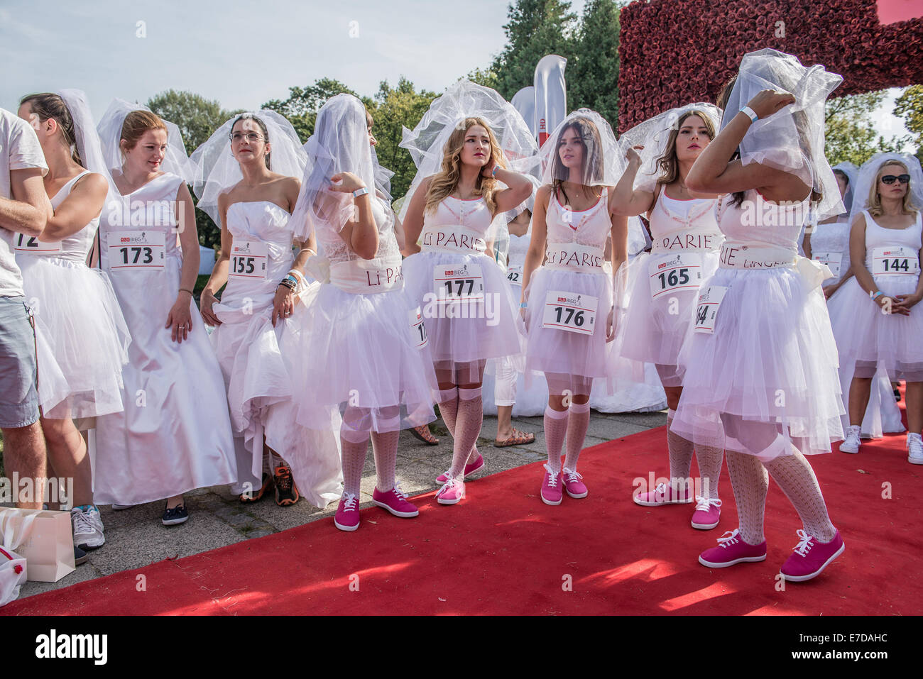 Warsaw, Poland. 15th September, 2014. Participants of the first Polish Wedding Dress Run in Agrykola Park in Warsaw. The collected money from charity run will cover cost of rehabilitation of Julia Torla (Miss Wheelchair 2014 in Poland) who is disabled due to serious back injury after car accident. Credit:  kpzfoto/Alamy Live News Stock Photo