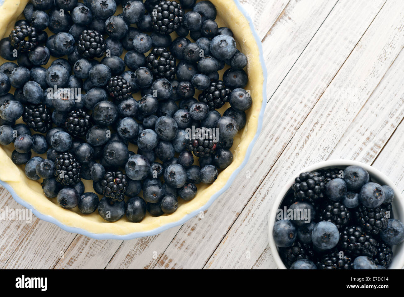 Tasty homemade pie with blueberries and blackberries on wooden table. Top view. Stock Photo