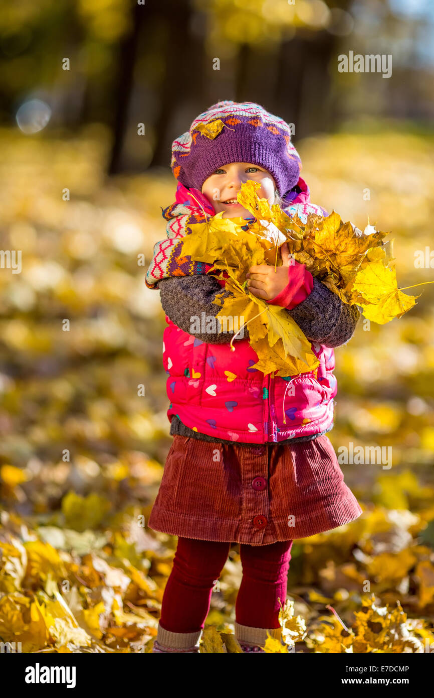 Little girl playing with autumn leaves Stock Photo - Alamy