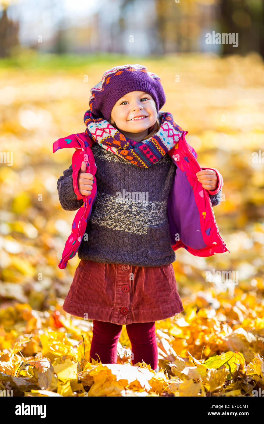 Happy little girl playing in the autumn park Stock Photo - Alamy
