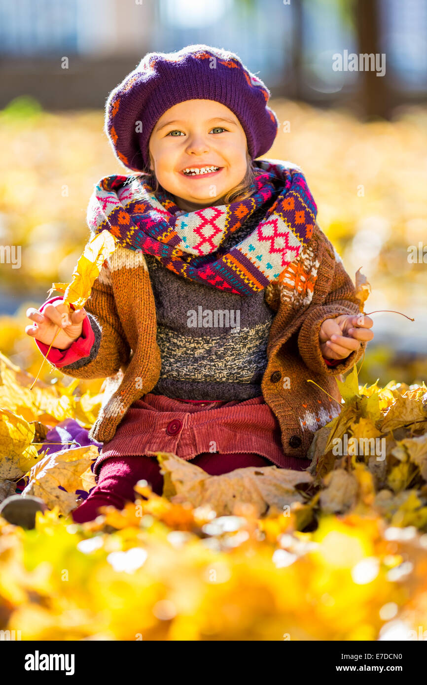 Little girl playing with autumn leaves Stock Photo - Alamy