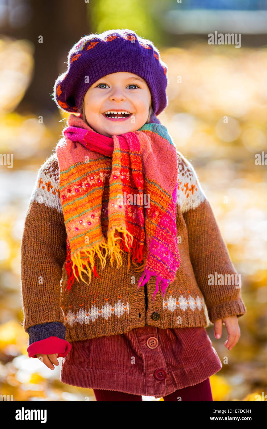 Happy little girl playing in the autumn park Stock Photo - Alamy