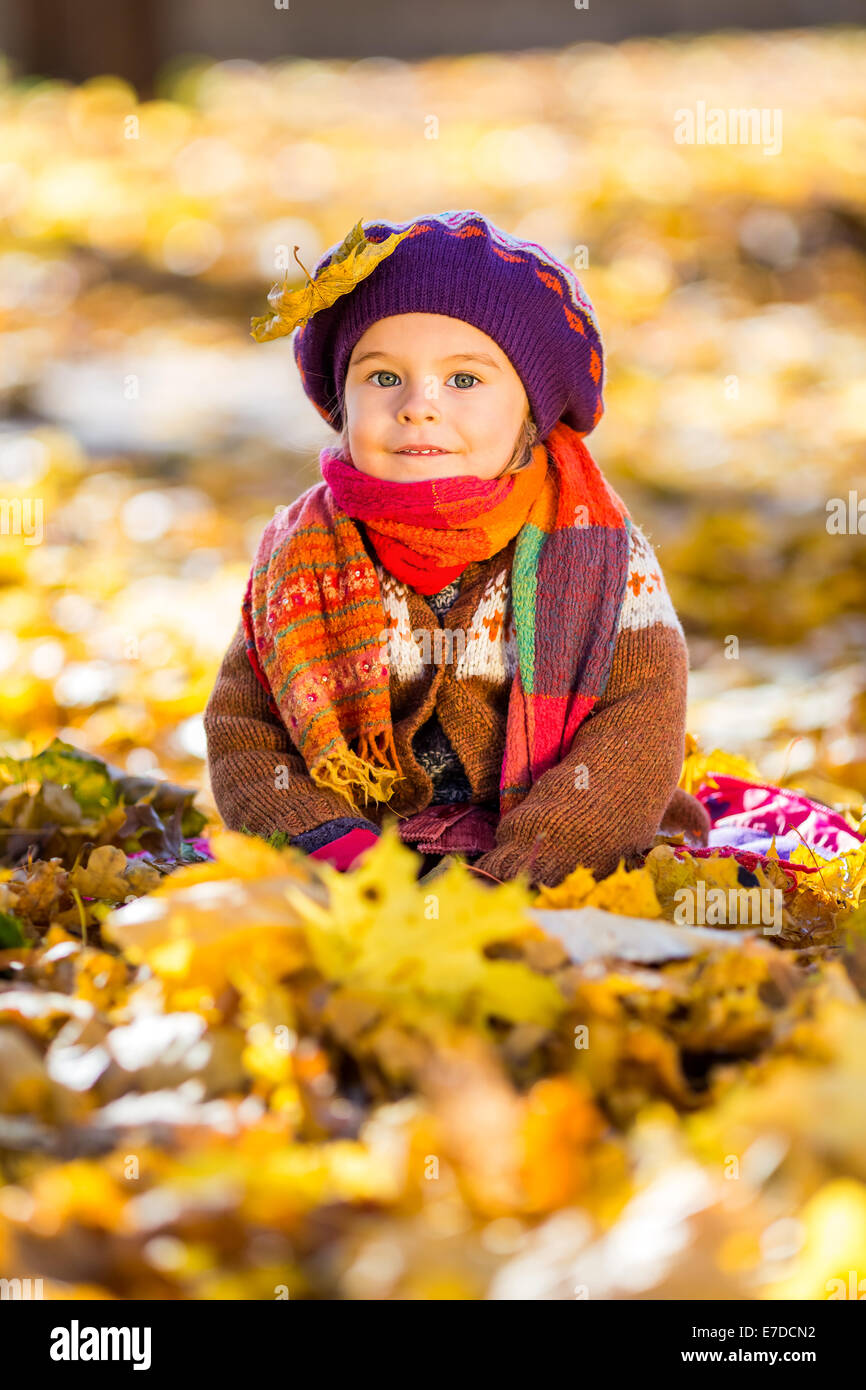 Happy little girl playing in the autumn park Stock Photo - Alamy