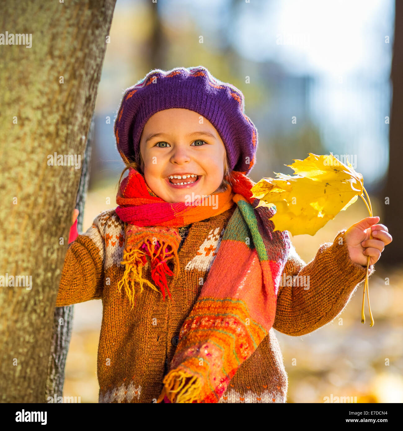 Happy little girl playing in the autumn park Stock Photo - Alamy