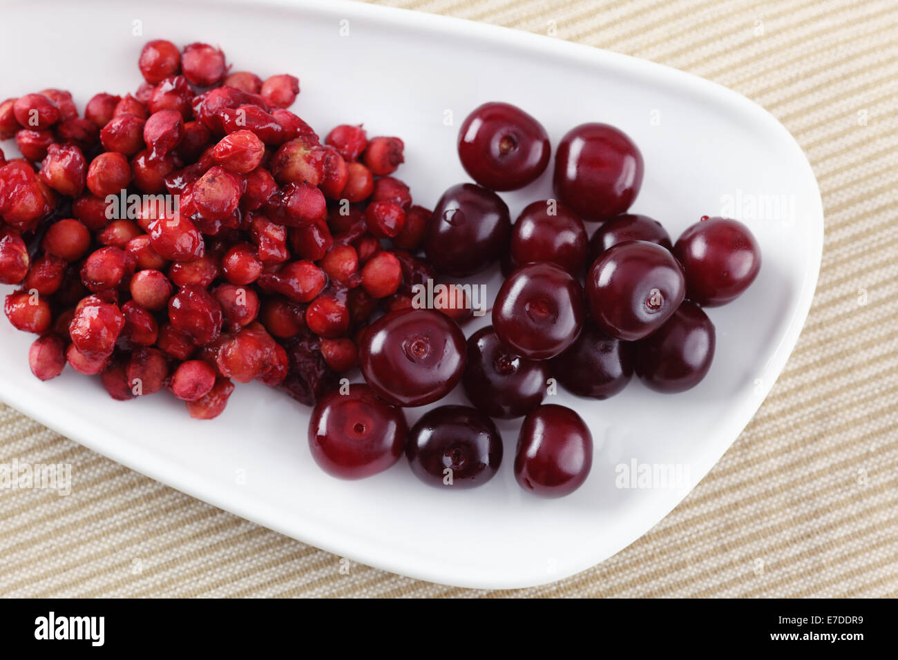Cherries and cherry stones (pits) on a plate Stock Photo Alamy