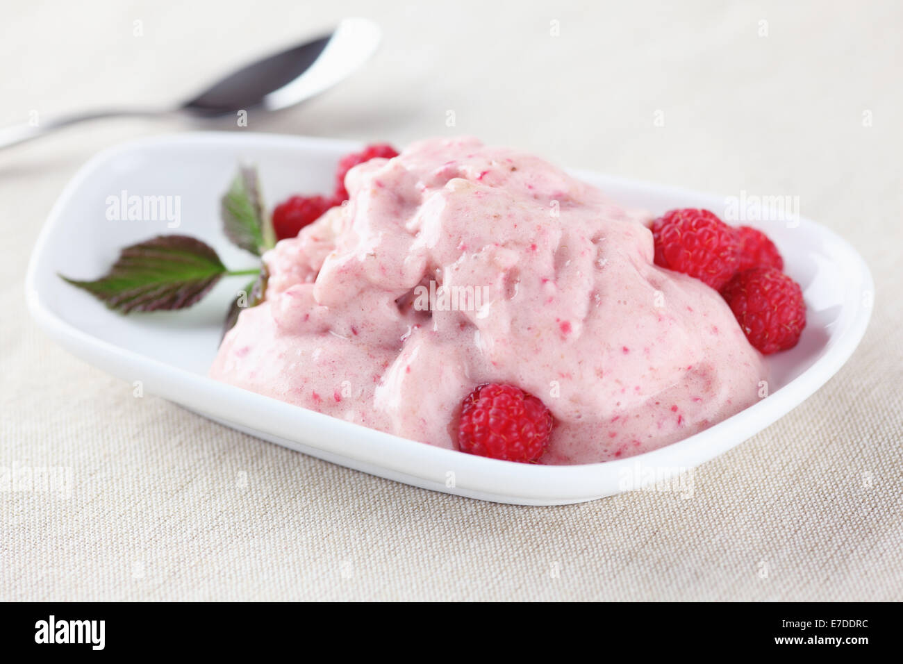 Raw banana ice cream with raspberries. ingredients: bananas, honey, raspberry. Raw food only. Stock Photo