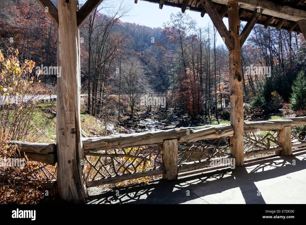 Rustic log and timber covered bridge leads to private development along west fork Tuckasegee River just south of Tuckasegee Lake Stock Photo