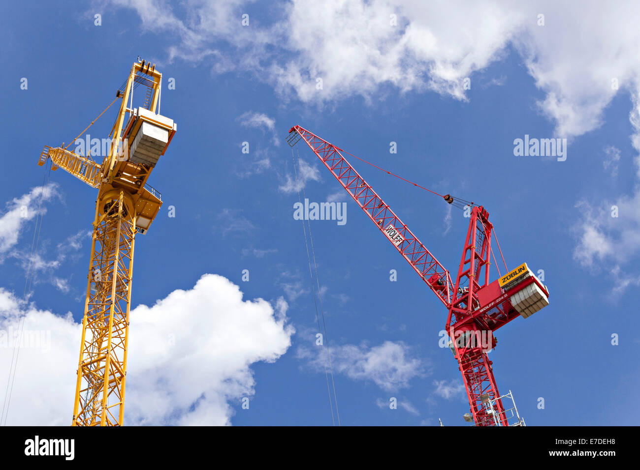 Industrial cranes against cloudy blue sky Stock Photo