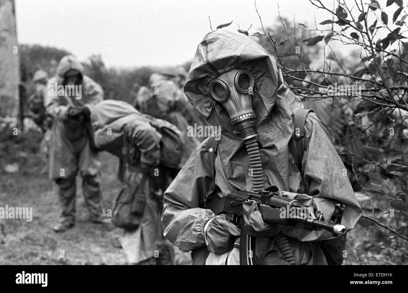 Members of the paramilitary combat troops of a Berlin enterprise wear their  complete protective equipment including gas masks during an exercise near  Berlin, undated from the start of the 1980s. The members