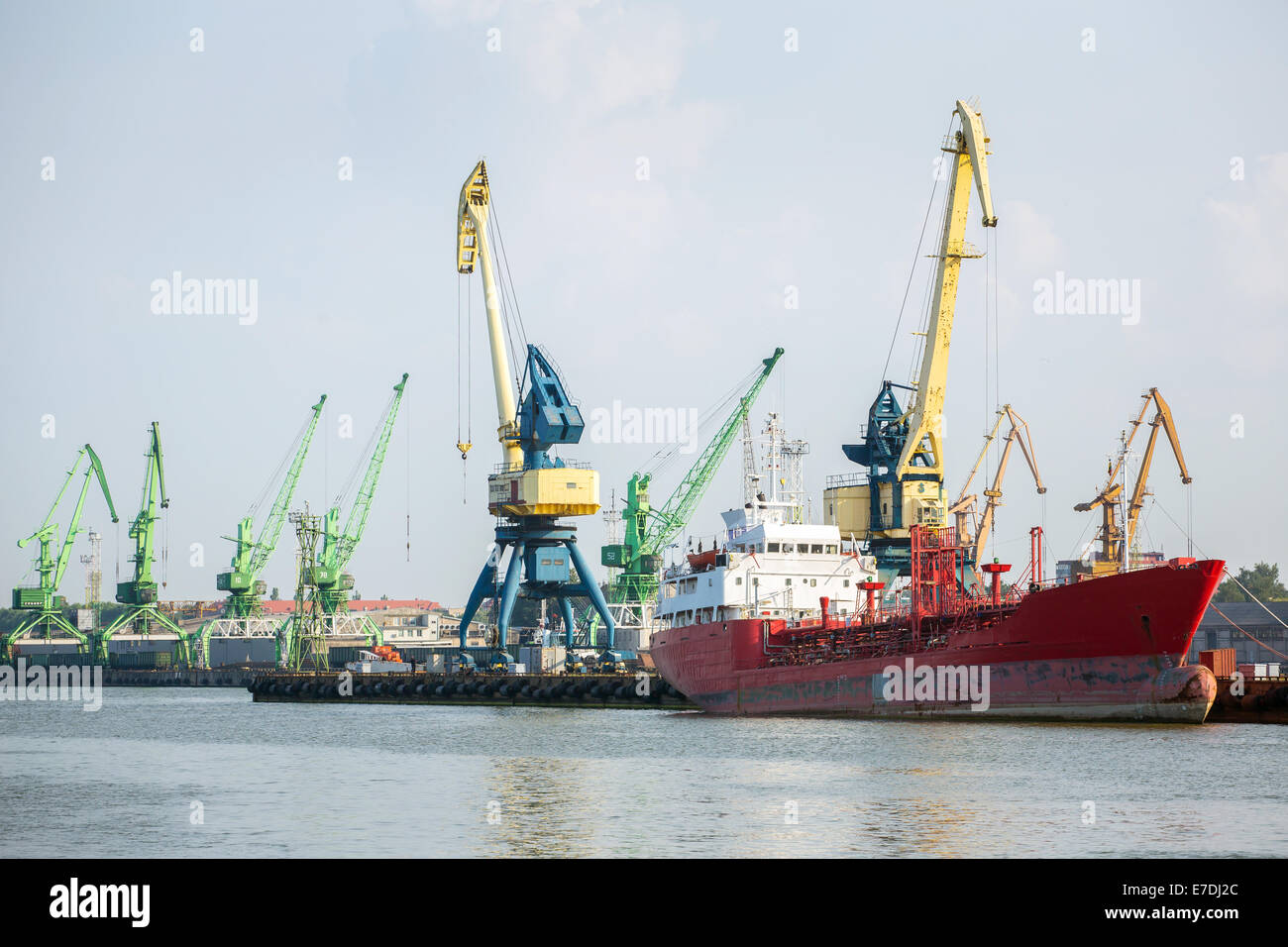 Cranes and ship in Klaipeda harbor, Lithuania Stock Photo