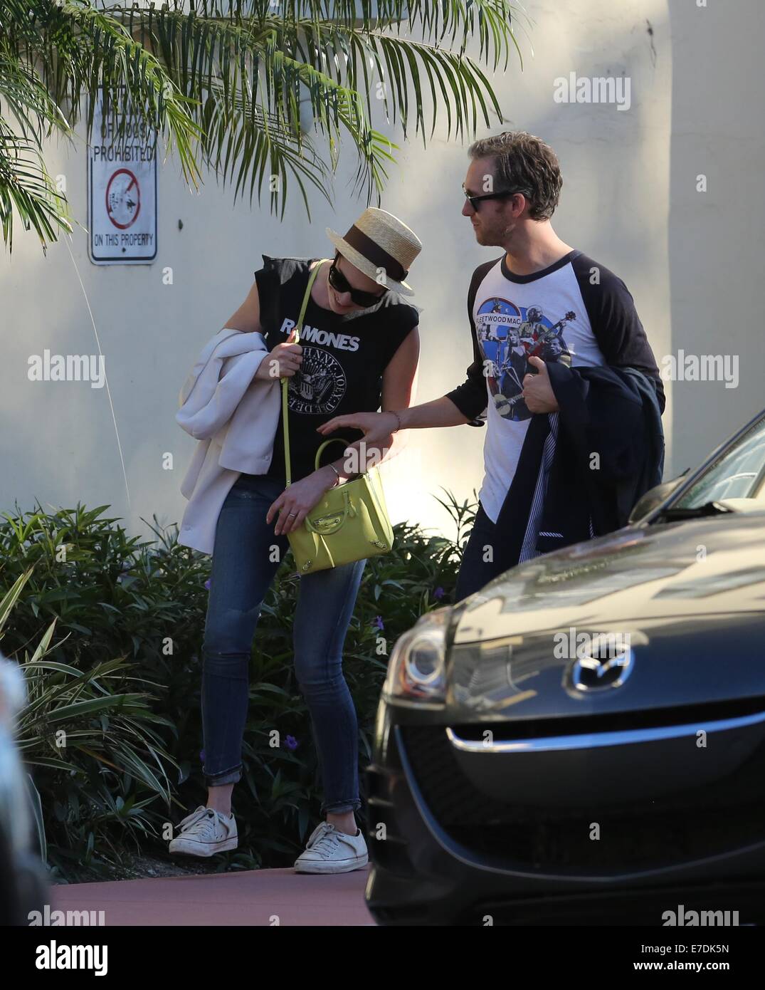 Anne Hathaway wearing a Ramones t-shirt while husband Adam Shulman featured wearing a Fleetwood Mac top while out and about walking around South Beach after lunch  Featuring: Anne Hathaway,Adam Shulman Where: Miami Beach, Florida, United States When: 09 Mar 2014 Stock Photo