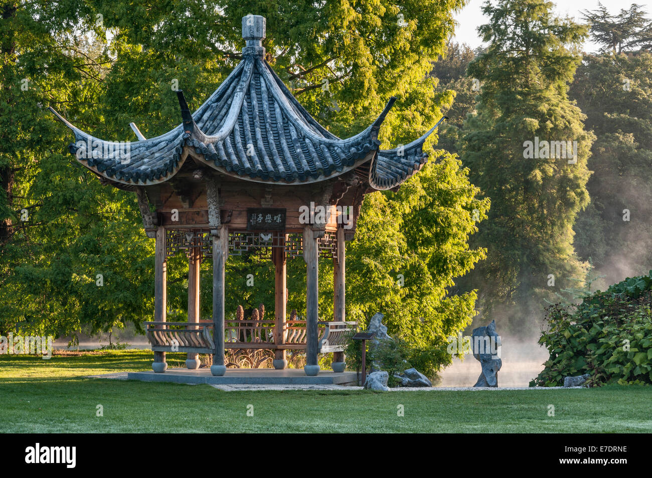 The Royal Horticultural Society (RHS) gardens, Wisley, Surrey, UK. The Chinese Pavilion at sunrise, mist on the lake Stock Photo