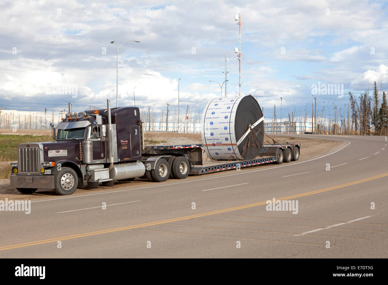 Heavy haulage truck carrying industrial load parked on roadside, Fort McMurray, Alberta, Canada Stock Photo