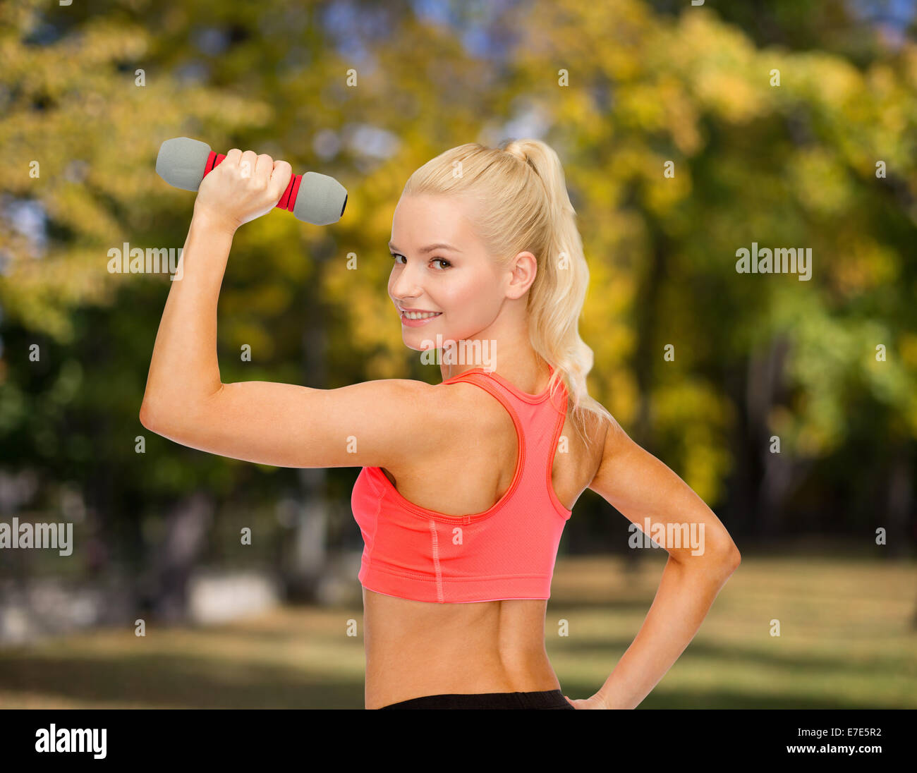 young sporty woman with light dumbbell Stock Photo