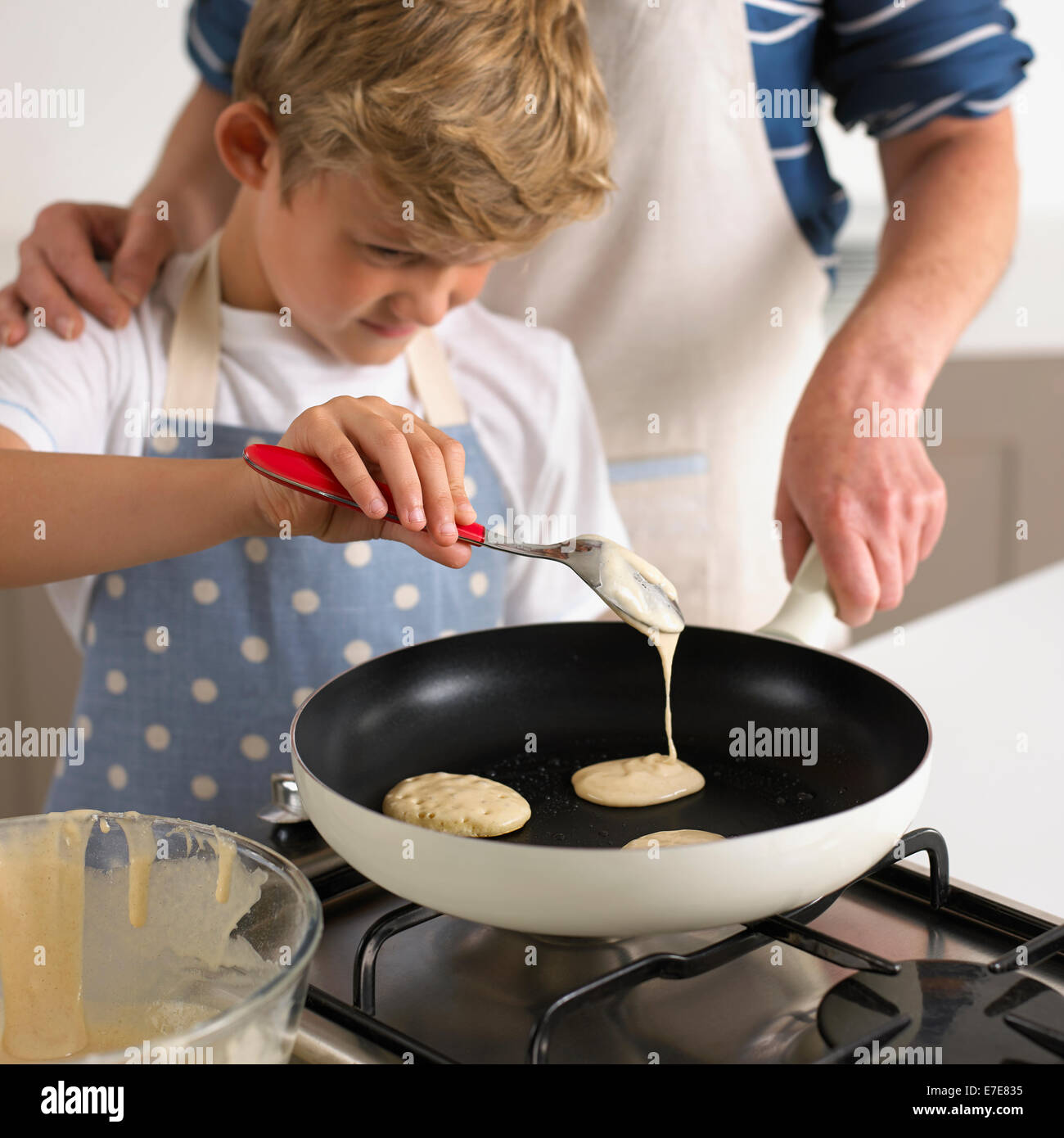 Pouring pancake batter in a frying pan Stock Photo Alamy