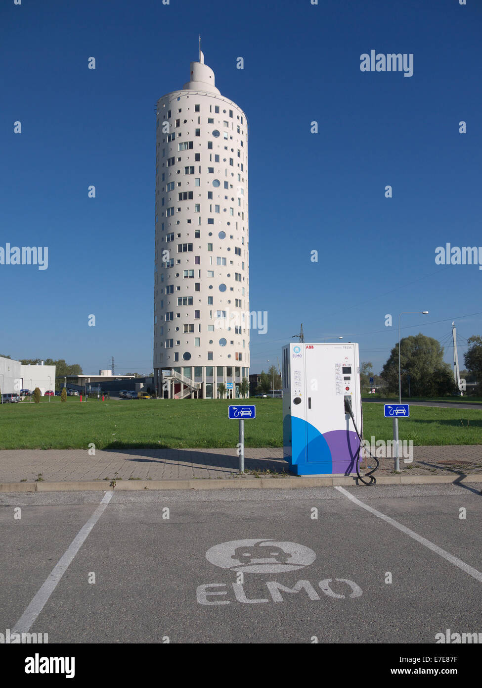 Elmo Electric car quick charger in foreground and modern residential house ( Tigutorn ) in the bacground. Tartu. Estonia Stock Photo