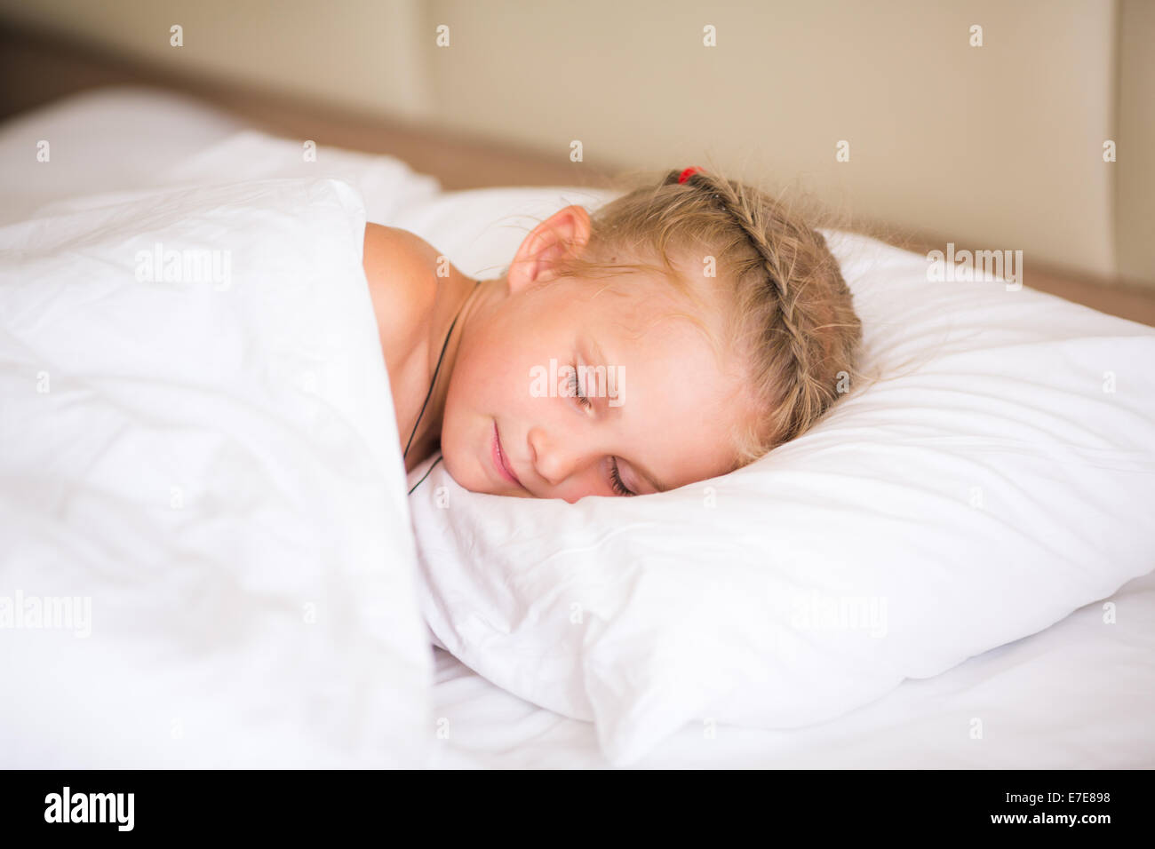 Adorable little girl sleeping in the bed Stock Photo - Alamy