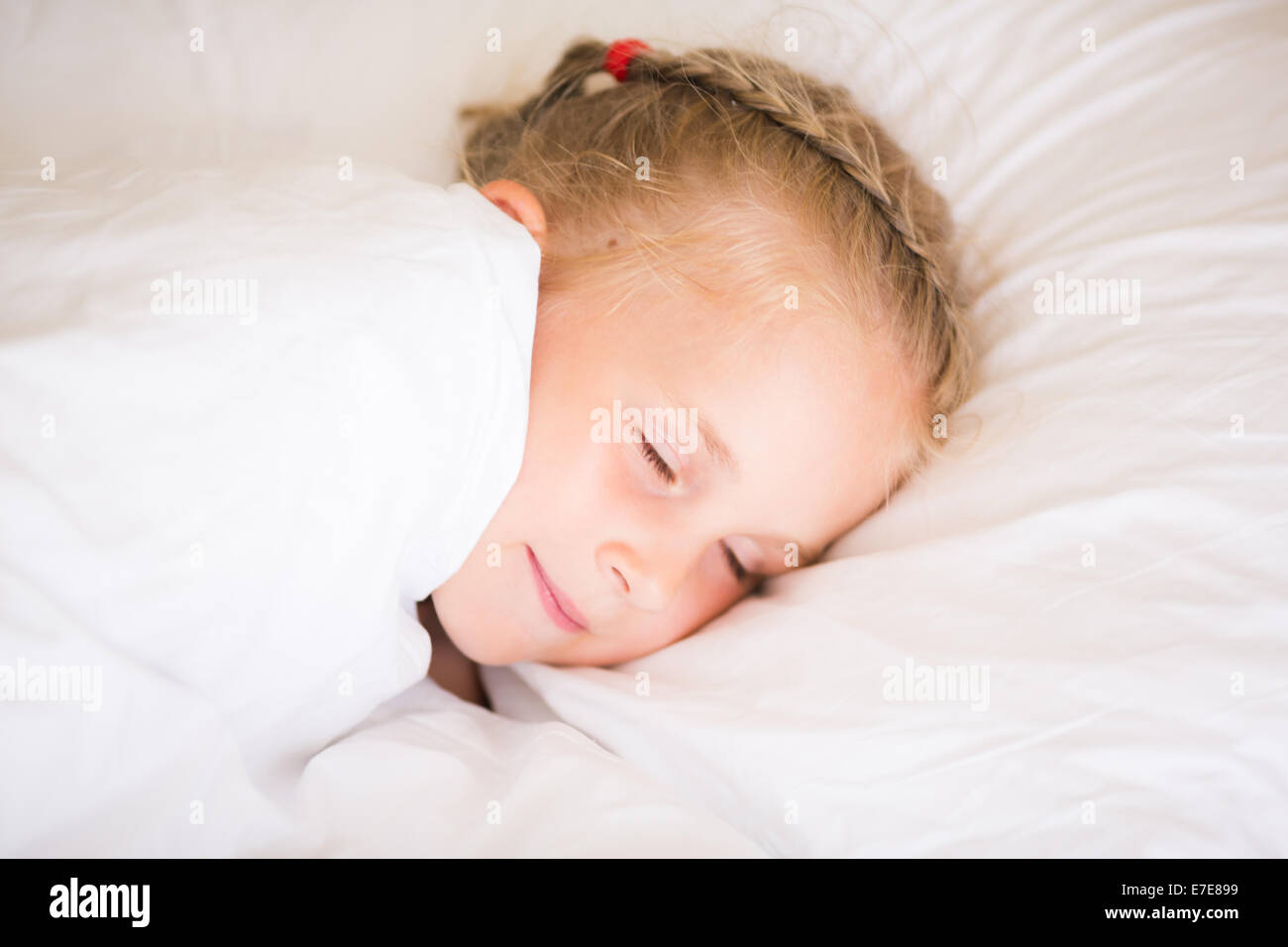 Adorable little girl sleeping in the bed Stock Photo - Alamy