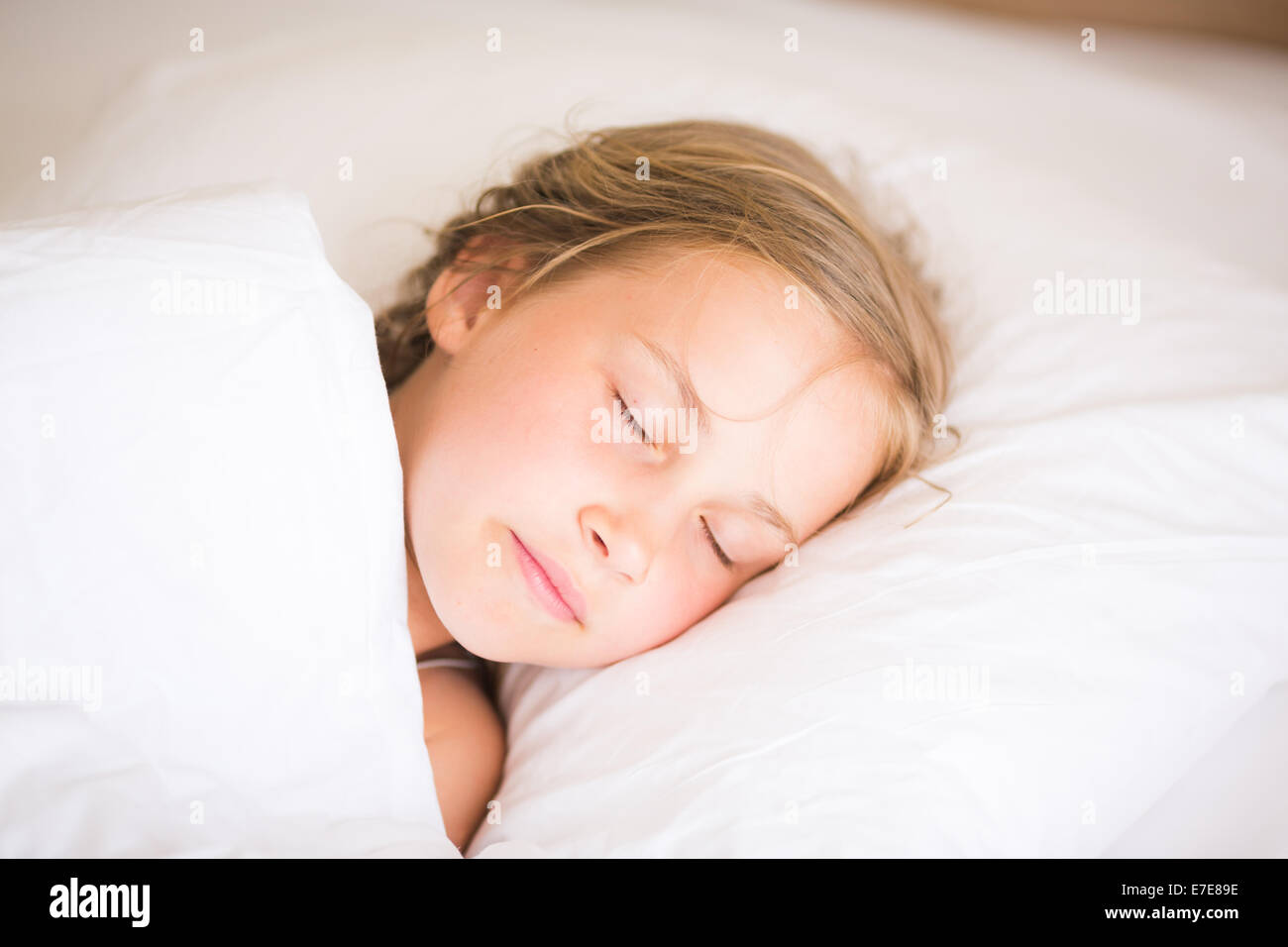 Adorable little girl sleeping in the bed Stock Photo - Alamy