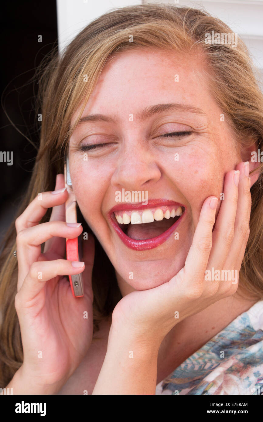 Happy woman talking on telephone Stock Photo