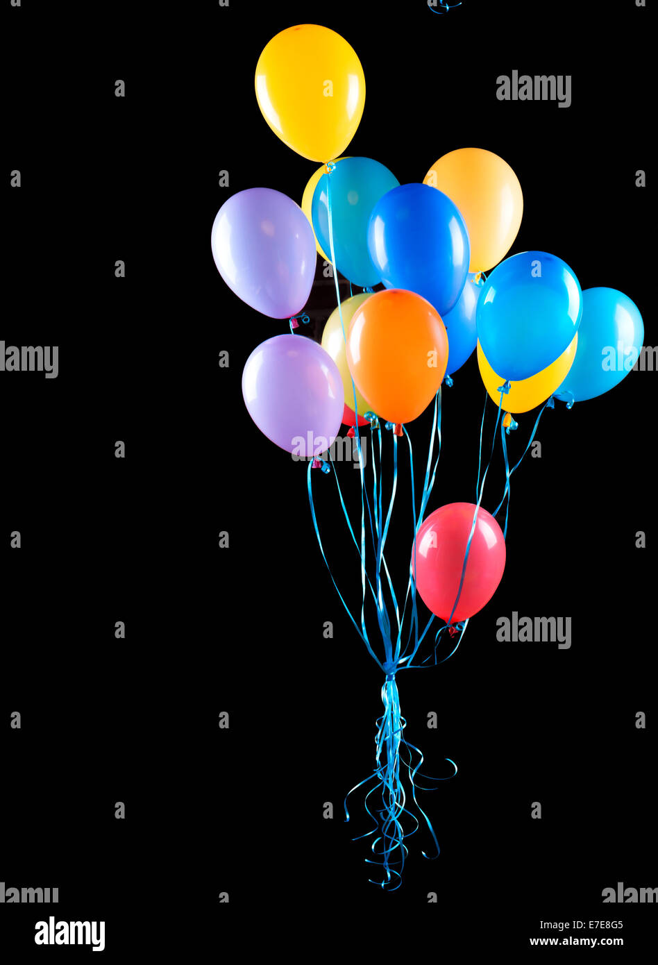 flying balloons isolated on a black background Stock Photo - Alamy